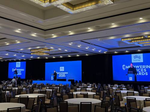 Custom event branding on stage and screens produced by Prime AV