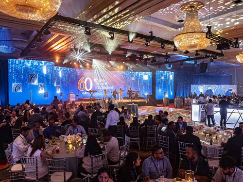Custom gala stage with a branded backdrop built by Prime AV