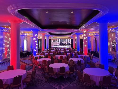 Custom lighting design washing a gala ballroom in color by Prime AV