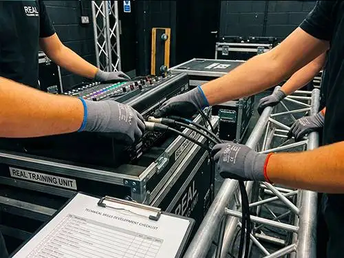 Experienced Prime AV crew training a new technician on professional AV equipment