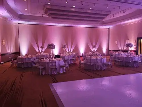Color uplighting washing venue walls at an event in the Washington, DC metro area