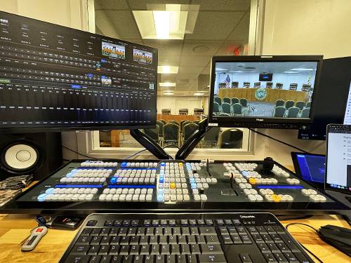 Broadcast control desk overseeing live video production at an event venue in the DMV