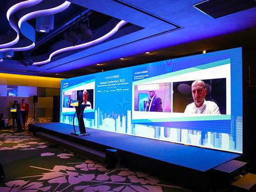 Large LED video wall on a conference stage produced by Prime AV
