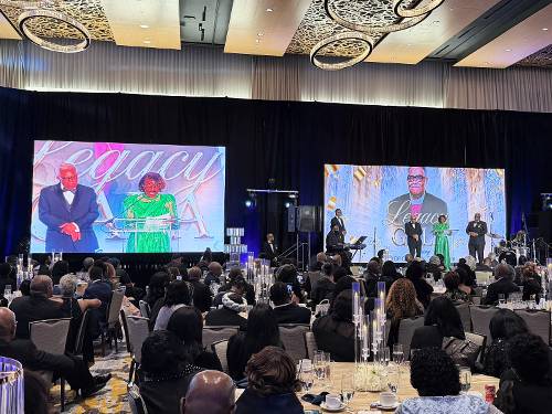 Large video screens flanking a gala stage produced by Prime AV